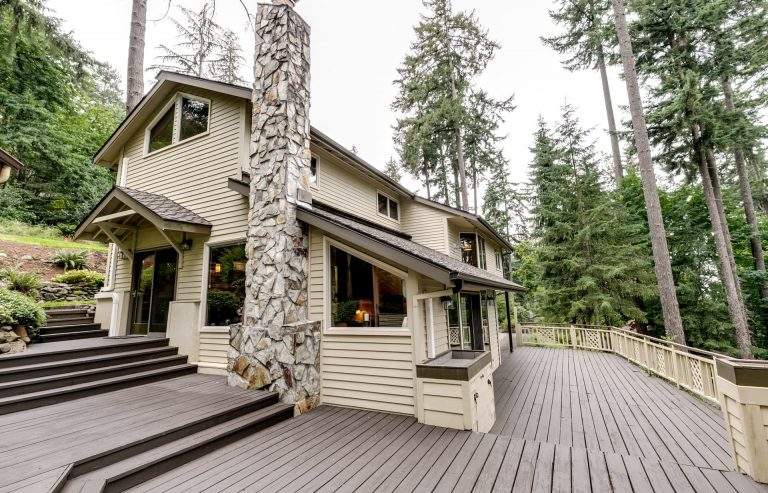 Churchill neigborhood Eugene modern home with impressive decking and stone chimney
