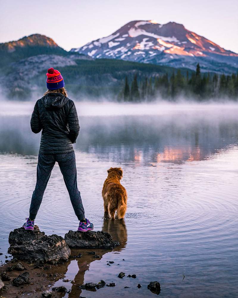 Woman with her dog at Sparks Lake, a destination for Eugene and Bend homeowners
