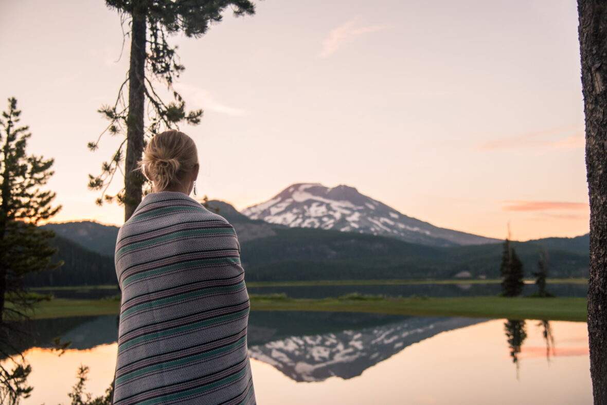 Woman in blanket at Sparks Lake in Oregon